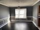 Bright dining room with a window and dark hardwood floors at 8531 Friendship Ln, Indianapolis, IN 46217