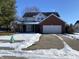 Brick two-story house with attached garage and snow-covered driveway at 8531 Friendship Ln, Indianapolis, IN 46217