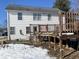 Two story white house with a wooden deck and some patchy snow on the ground at 8531 Friendship Ln, Indianapolis, IN 46217