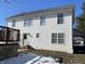 Rear view of a two-story house with white siding and a small deck at 8531 Friendship Ln, Indianapolis, IN 46217