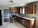 Kitchen with oak cabinets and stainless steel appliances at 8531 Friendship Ln, Indianapolis, IN 46217