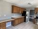 Kitchen with oak cabinets, stainless steel appliances, and tile floor at 8531 Friendship Ln, Indianapolis, IN 46217