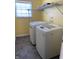 Laundry room with washer, dryer, and overhead shelving at 8531 Friendship Ln, Indianapolis, IN 46217