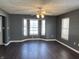 Living room with bay window, dark hardwood floors, and gray walls at 8531 Friendship Ln, Indianapolis, IN 46217
