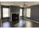 Living room with fireplace, dark hardwood floors, and ceiling fan at 8531 Friendship Ln, Indianapolis, IN 46217