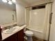 Functional bathroom features a vanity with a sink, toilet, and tub/shower combination at 8660 S Peoga Rd, Trafalgar, IN 46181