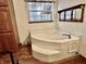 A cozy bathroom featuring a corner jacuzzi tub and a warm, inviting atmosphere at 8660 S Peoga Rd, Trafalgar, IN 46181