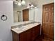 Bathroom vanity featuring dual sinks, wood cabinets, and a bright, well-lit mirror at 8660 S Peoga Rd, Trafalgar, IN 46181