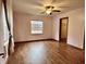 Bright bedroom featuring hardwood floors, ceiling fan, and a window offering ample natural light at 8660 S Peoga Rd, Trafalgar, IN 46181