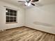 Bedroom with wood-look flooring, ceiling fan, and a bright window at 8660 S Peoga Rd, Trafalgar, IN 46181
