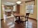 Inviting dining area featuring a round wooden table and chairs, complemented by natural light from a window at 8660 S Peoga Rd, Trafalgar, IN 46181