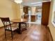 Cozy dining area featuring a wooden table set with wrought-iron chairs and warm lighting adjacent to the kitchen at 8660 S Peoga Rd, Trafalgar, IN 46181