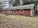 Cozy one-story home features wood siding, multiple windows, and a charming front porch area at 8660 S Peoga Rd, Trafalgar, IN 46181