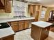 Functional kitchen with island, wood cabinets, and stainless steel appliances at 8660 S Peoga Rd, Trafalgar, IN 46181