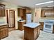 Spacious kitchen with an island, cabinetry, and appliances at 8660 S Peoga Rd, Trafalgar, IN 46181
