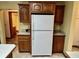 Bright kitchen features wood cabinets, countertops, and a white refrigerator at 8660 S Peoga Rd, Trafalgar, IN 46181
