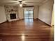 Spacious living room boasts a stone fireplace, hardwood floors, and a sliding door leading to the deck at 8660 S Peoga Rd, Trafalgar, IN 46181