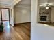 Open-concept living area with hardwood floors and a view into the living room with stone fireplace feature at 8660 S Peoga Rd, Trafalgar, IN 46181