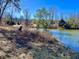 Picturesque pond with clear water, grassy shoreline, and lush greenery at 8660 S Peoga Rd, Trafalgar, IN 46181