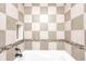 Bathroom with a checkered tile design and a built-in bathtub at 9829 Chambray Dr, Indianapolis, IN 46280