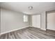 Bright bedroom featuring gray walls, wood-look floors, and a closet at 9829 Chambray Dr, Indianapolis, IN 46280