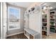 Functional mudroom with built-in bench, storage, and access to pantry at 9847 Gallop Ln, Fishers, IN 46040