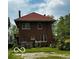 Picture of the rear of the property highlighting the yard and architectural details at 1023 Franklin St, Columbus, IN 47201