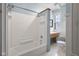 Bathroom with white tiled shower and bathtub at 1023 Franklin St, Columbus, IN 47201