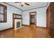 Hardwood floor bedroom with fireplace, built-in shelving and large windows at 1023 Franklin St, Columbus, IN 47201