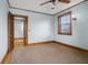 Bedroom with brown carpet, ceiling fan and door to another room at 1023 Franklin St, Columbus, IN 47201