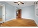 Light blue bedroom with hardwood floors and ceiling fan at 1023 Franklin St, Columbus, IN 47201