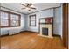 Spacious bedroom with hardwood floors, fireplace, and large windows at 1023 Franklin St, Columbus, IN 47201