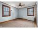 Light blue bedroom with brown carpet, ceiling fan and wood trim at 1023 Franklin St, Columbus, IN 47201