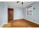 Bedroom with hardwood floors, ceiling fan and door to another room at 1023 Franklin St, Columbus, IN 47201