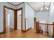 Upstairs hallway with hardwood floors and access to bedrooms and bathroom at 1023 Franklin St, Columbus, IN 47201