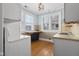 Bright kitchen with hardwood floors and white cabinetry at 1023 Franklin St, Columbus, IN 47201