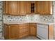 Corner kitchen with oak cabinets and dishwasher at 1023 Franklin St, Columbus, IN 47201