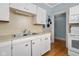 Kitchen features white cabinets and double sink at 1023 Franklin St, Columbus, IN 47201