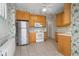 Bright kitchen featuring wood cabinets, stainless steel appliances, and tile flooring at 1023 Franklin St, Columbus, IN 47201