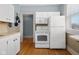 White kitchen with appliances and hardwood floors at 1023 Franklin St, Columbus, IN 47201