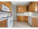Kitchen with oak cabinets and tiled floor at 1023 Franklin St, Columbus, IN 47201