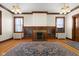 Living room with hardwood floors, fireplace, and built-ins at 1023 Franklin St, Columbus, IN 47201