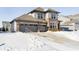 Two-story home with gray siding and brick accents, three-car garage, and snowy yard at 10500 Sanford Ct, Fishers, IN 46040