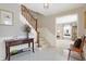 Bright entryway with tiled floor, staircase, and console table at 12104 Windsor Dr, Carmel, IN 46033