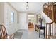 Spacious foyer with tiled floor, staircase, and view into dining area at 12104 Windsor Dr, Carmel, IN 46033