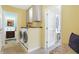 Laundry room with washer, dryer, cabinets, and access to a half bath at 12104 Windsor Dr, Carmel, IN 46033