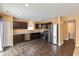 Modern kitchen with dark cabinets, stainless steel appliances and granite countertops at 12179 Country Side Dr, Cumberland, IN 46229