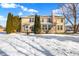 Backyard view of two story home with snow covered lawn and evergreen trees at 13678 Cunningham Dr, Carmel, IN 46074