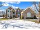 Brick two-story house with a landscaped yard and snow-covered lawn at 13678 Cunningham Dr, Carmel, IN 46074