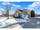 Brick house with an attached garage and snowy yard at 13678 Cunningham Dr, Carmel, IN 46074